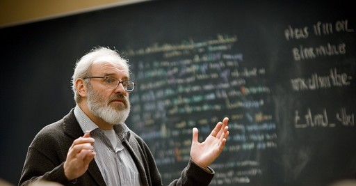 A lecturer presenting to a full auditorium